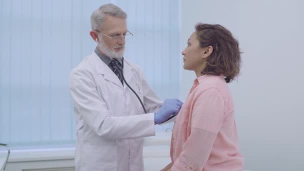 Médecin à l'écoute des poumons du patient, au stéthoscope, visite chez le médecin — Video