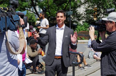 New York, New York-July Twenty Sixth, 2017: Jesse Watters from Fox News conducting interviews in Union Square Park, NYC. clipart