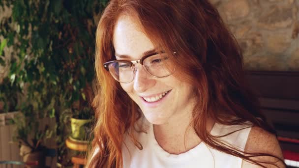 Young redhead girl in glasses — Stock Video