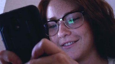 Tablet ile gözlüklü genç Kızıl saçlı kız