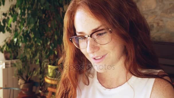 Young redhead girl in glasses — Stock Video