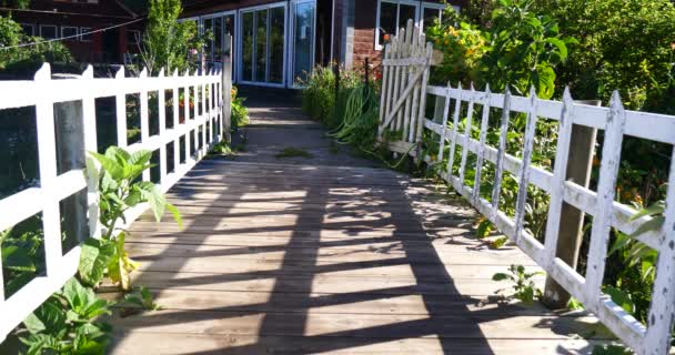英国庭院与白色篱芭 热带植被和木旅馆在山村 — 图库视频影像