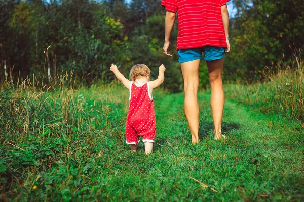 El niño aprende a caminar sobre la hierba — Foto de Stock