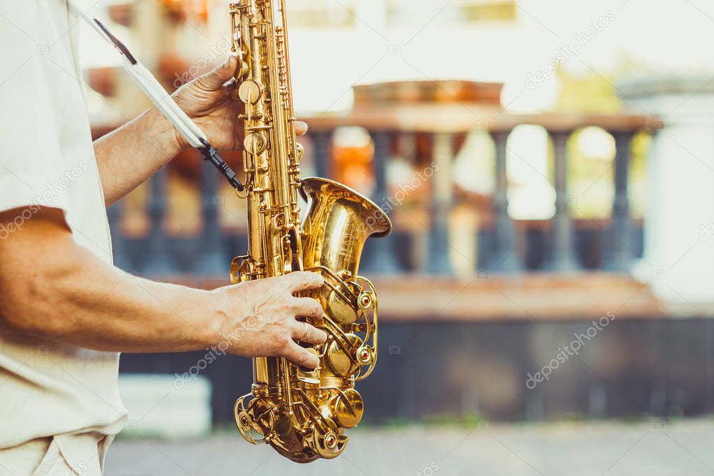 saxophonist plays on the street