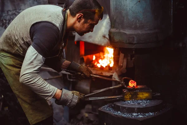blacksmith working in the forge