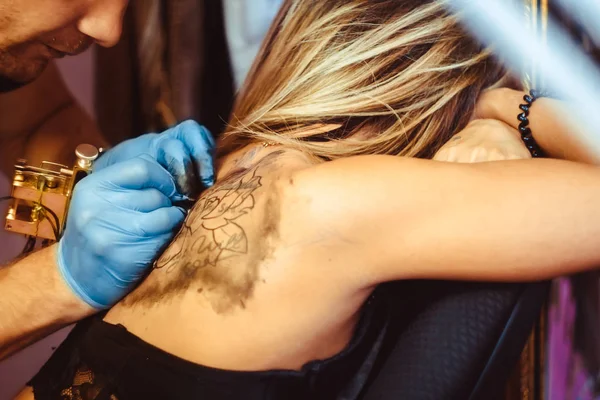 Mestre tatuagem mulher em suas costas — Fotografia de Stock