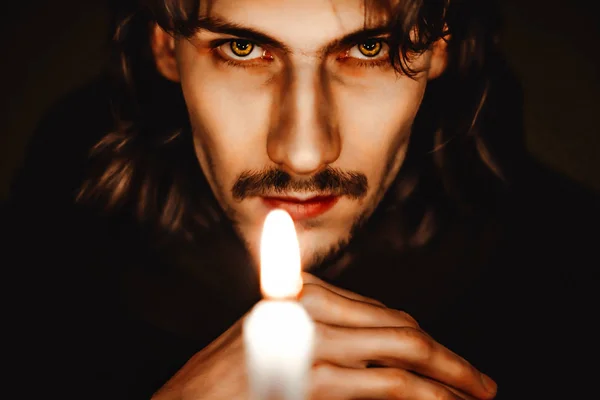 A monk with a candle — Stock Photo, Image