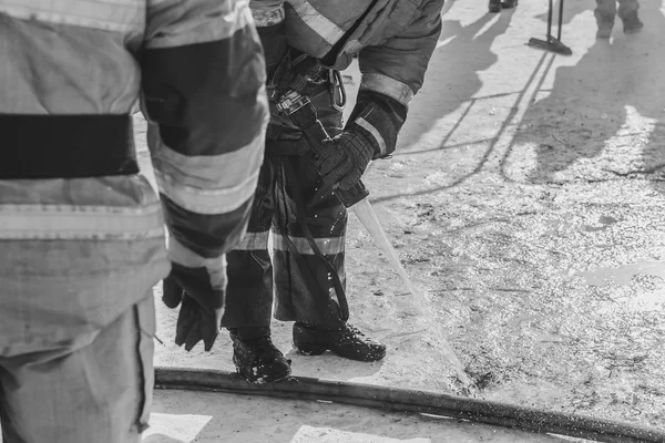 Firefighter extinguishes with water — Stock Photo, Image