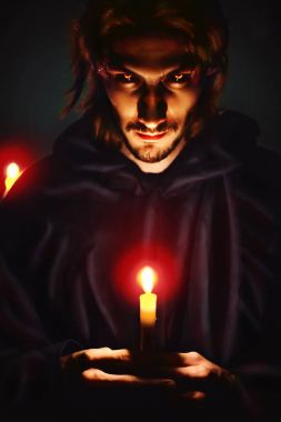 evil sorcerer with a candle clipart