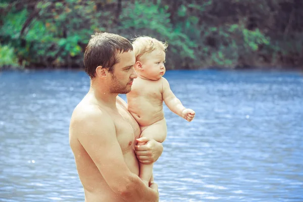 Dad and child bathe in the river