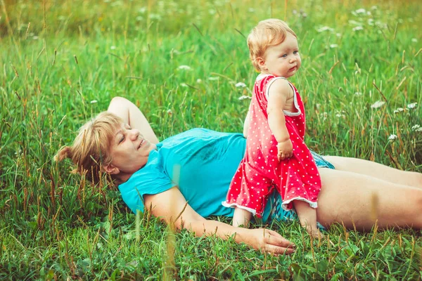 Grandmother with granddaughter on the grass — Stock Photo, Image