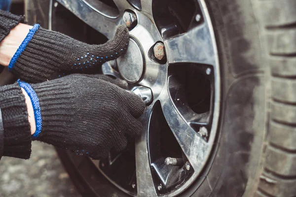 man changing wheel on a car