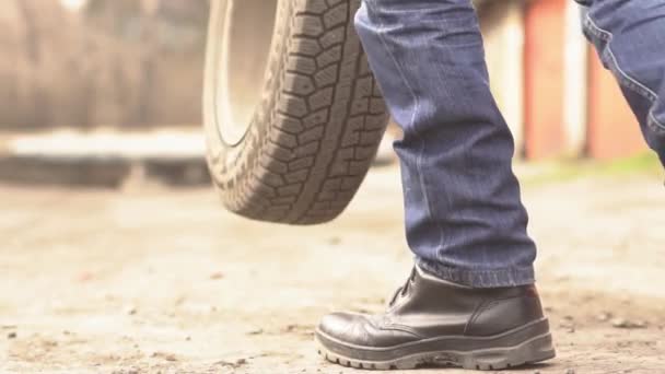 Mechanic Holding Car Tire Garage — Stock Video