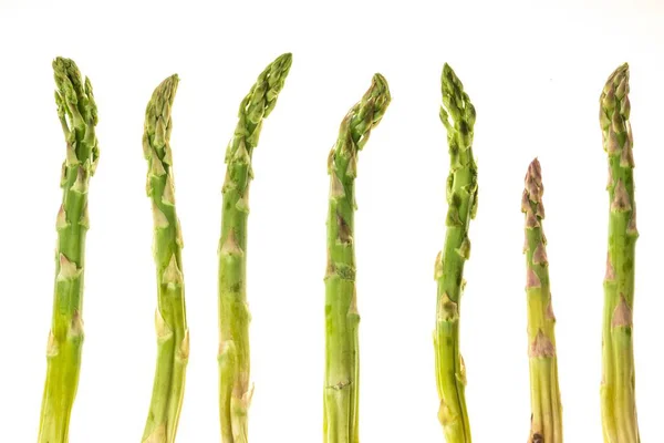 Fresh green asparagus shoots pattern, top view. Isolated over white. Food background asparagus flat lay pattern — Stock Photo, Image