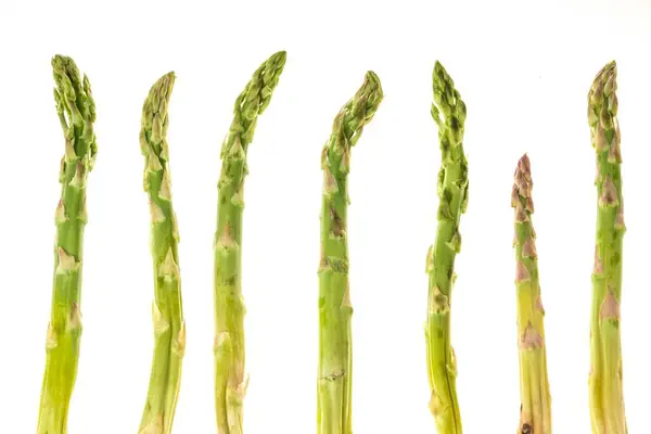 Fresh green asparagus shoots pattern, top view. Isolated over white. Food background asparagus flat lay pattern — Stock Photo, Image