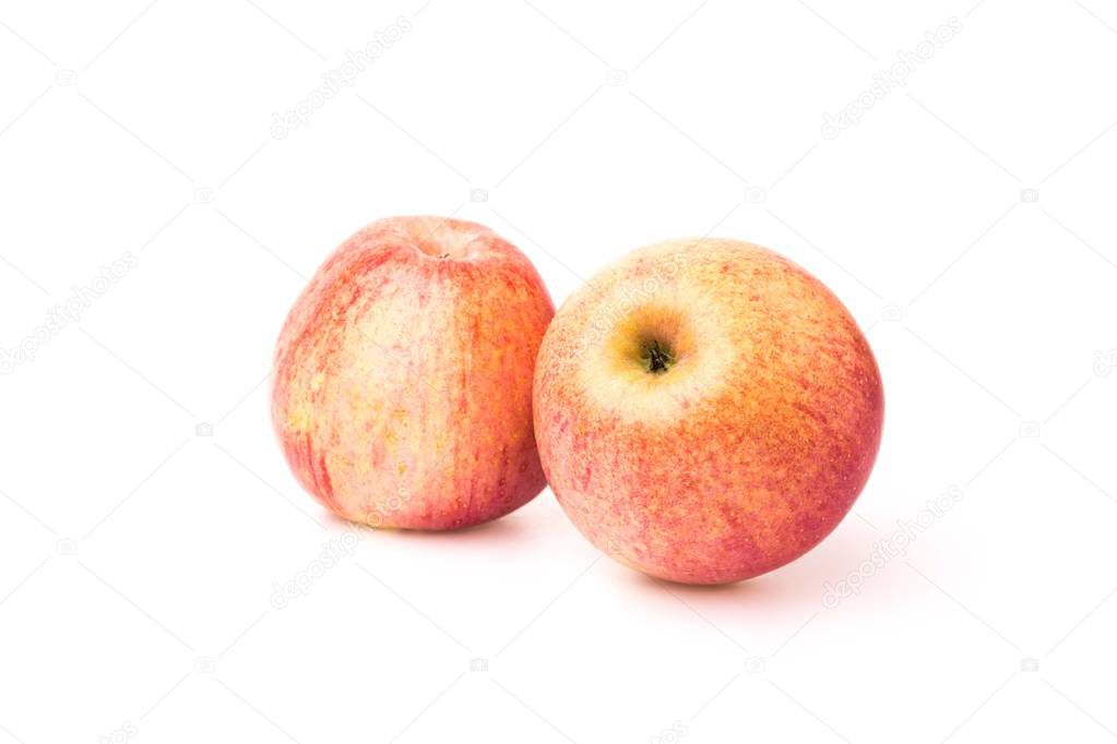 Fuji apples with drops of water on white background