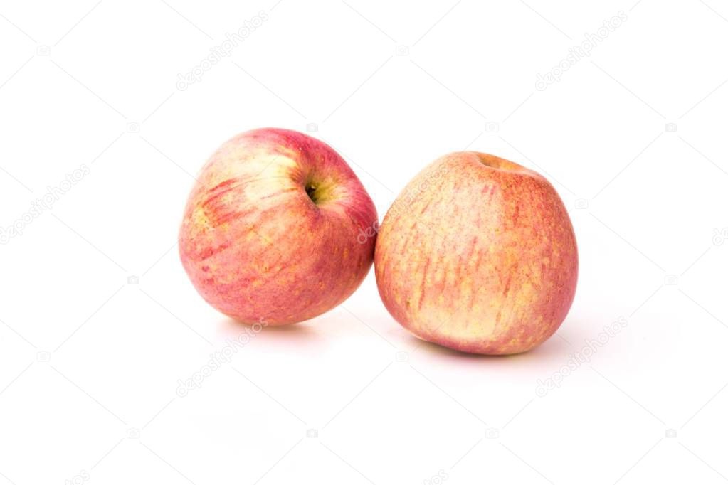 Fuji apples with drops of water on white background