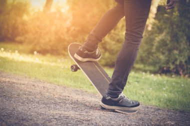 Bir skateboad sürme patenci. Ayakları üzerinde kapat