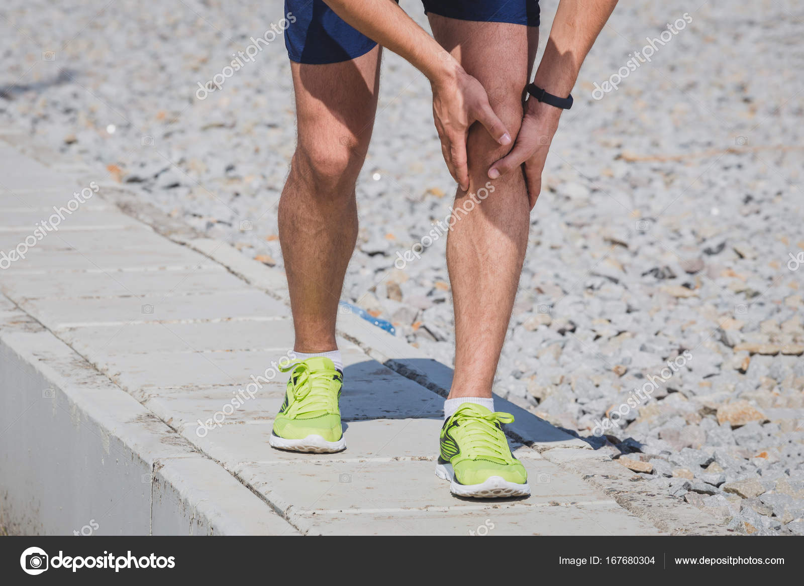 Jogging injury. Runner hands on knee. — Stock Photo © Zoffphoto 167680304