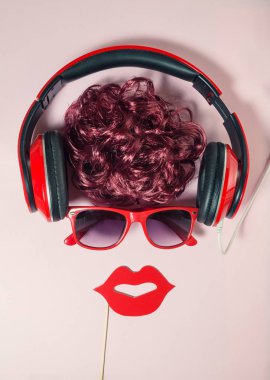 Fashionable urban hipster female listening music by using headphones. High angle view minimalistic abstract concept. clipart