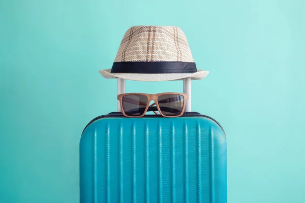 Bagaż z plaży tkane kapelusz i okulary na zielone tło wakacje minimalistycznym koncepcji — Zdjęcie stockowe