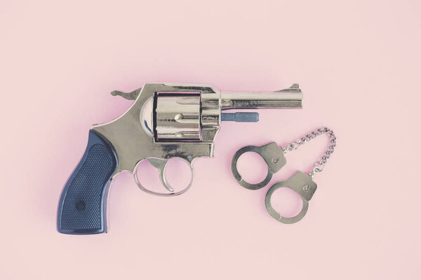 High angle view of gun and handcuffs. Police and crime concept.