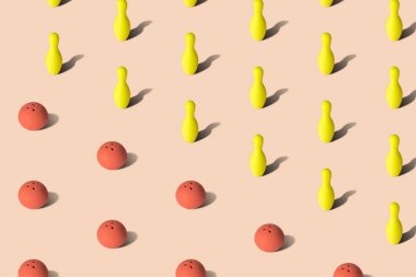 Kırmızı bowling topları ve sarı bovling lobutları pastel arka plan spor soyut.