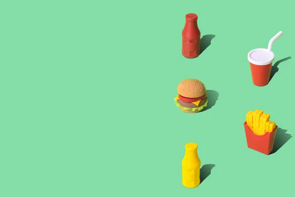 Fast food texture made of disposable cup, mustard and ketchup bottles with burger and french fries abstract on green with copy space. — Stock Photo, Image