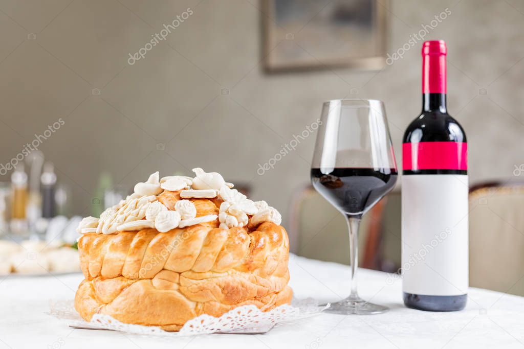 Wine and decorated bread on table for celebration a saint in Orthodox faith. Serbian traditional and cultural heritage.