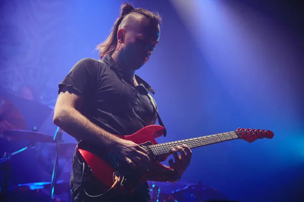 Guitarist performing on stage.