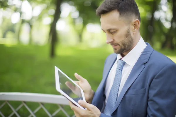 middle aged businessman working with tablet outdoor