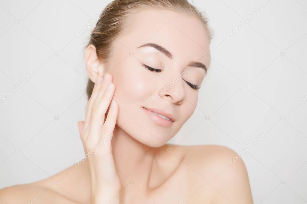 Health and beauty concept - beautiful young woman face on white with vivid shadow