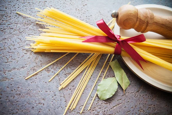 raw italian noodles spaghetti on table in kitchen