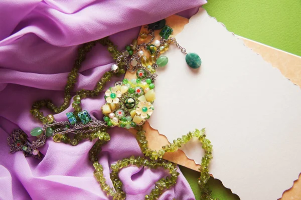 vintage colorful background with granny`s green necklace.