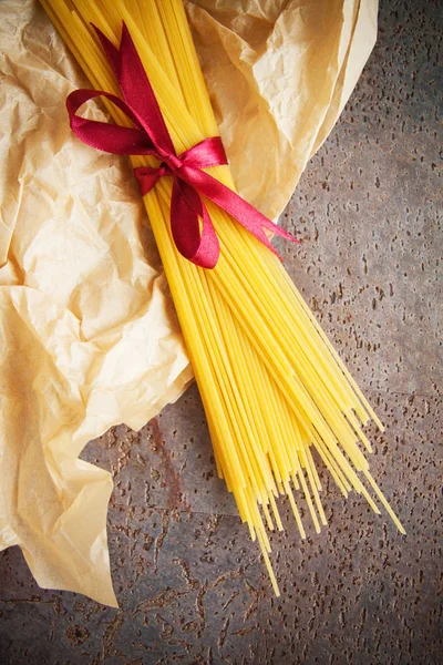 raw italian noodles spaghetti on table in kitchen