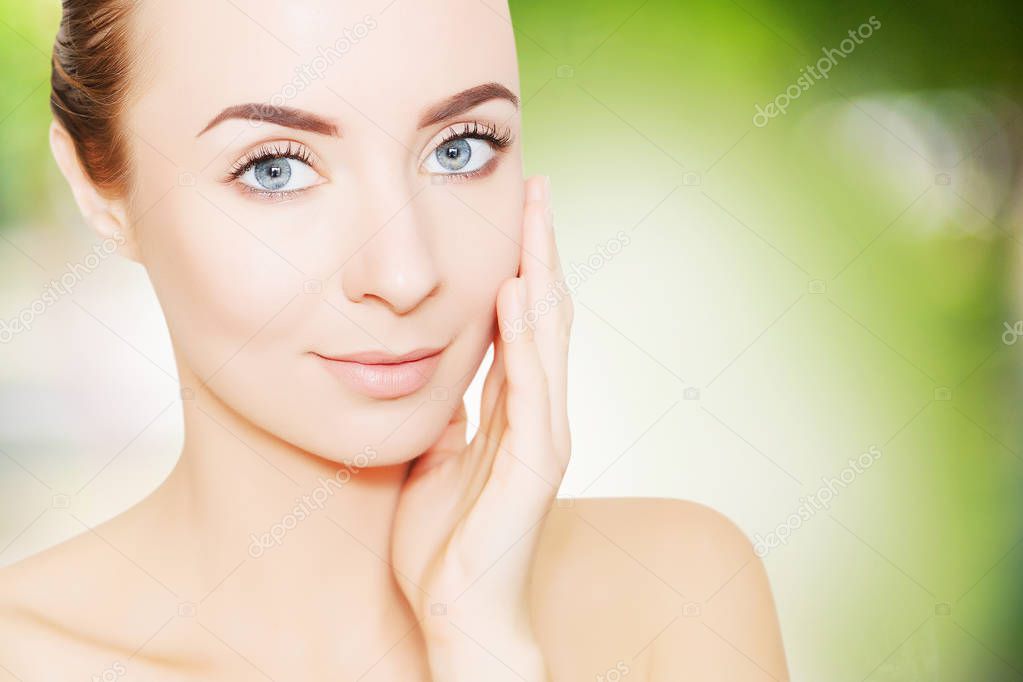 portrait of beautiful smiling woman with perfect skin over green