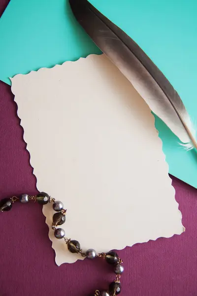 vintage background with black pearls and colorful papers