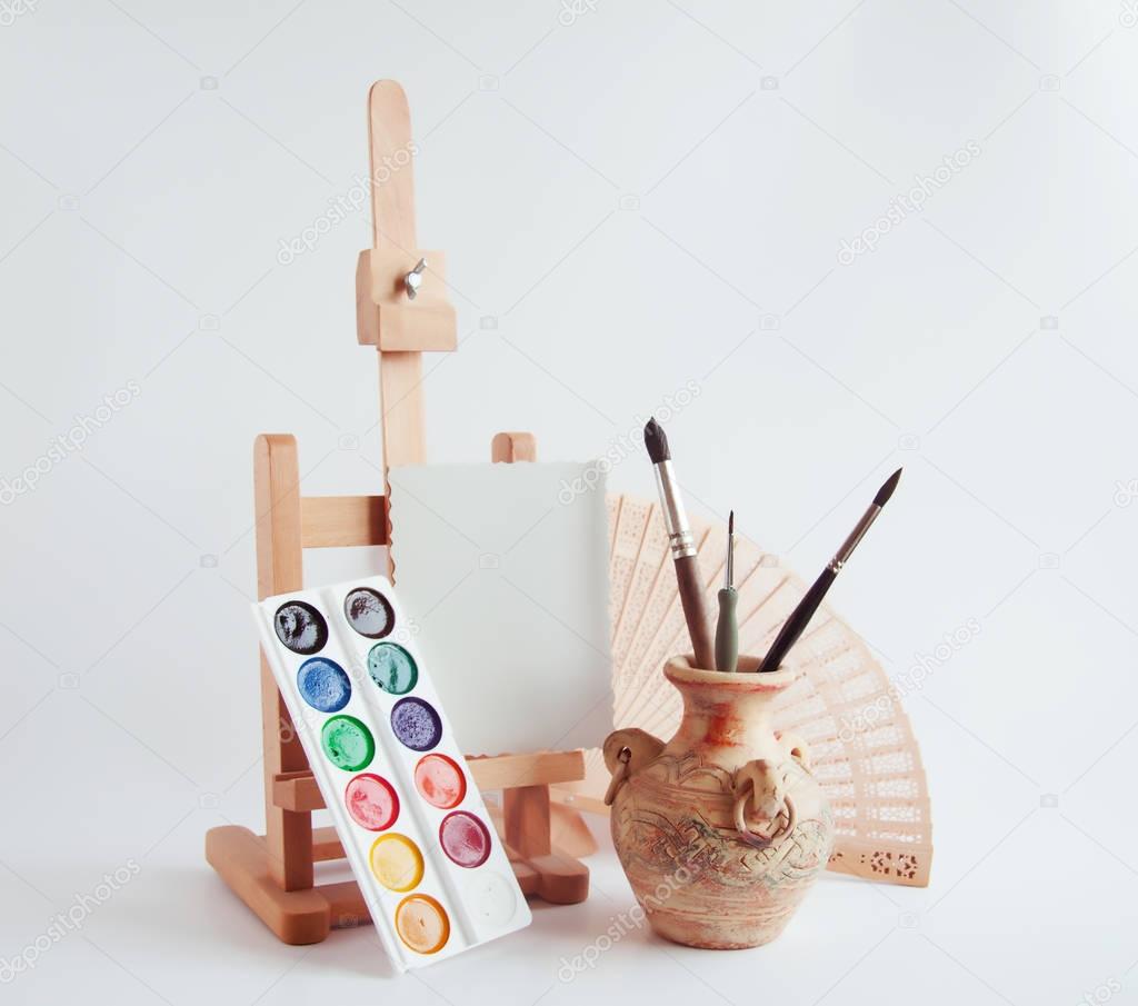 artistic still life with easel and paints