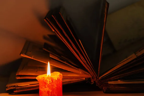 An old book and a candle — Stock Photo, Image