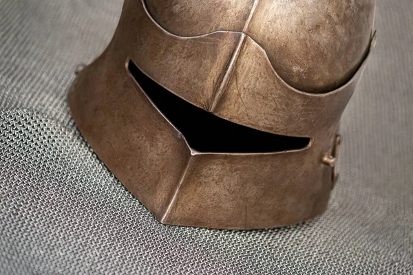 Close-up shot of a knight's helmet that lies on chain armor — Stock Photo, Image