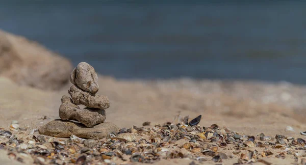 Zen concept. Object made of stone on the beach. Stone pyramid for meditation. Harmony and Meditation. Zen stones.