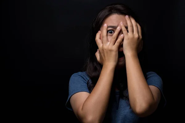 Mujer asustada sobre fondo negro aislado — Foto de Stock