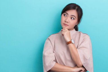 Asyalı kadın tecrit edilmiş arka planda düşünüyor