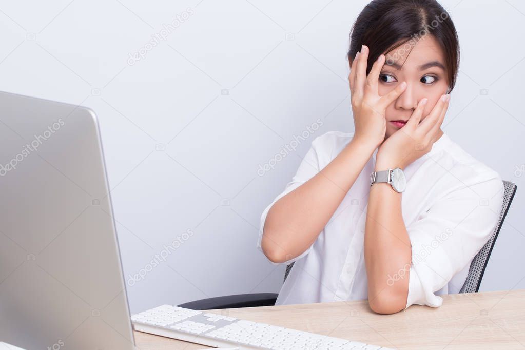 Woman use computer and she afraid something