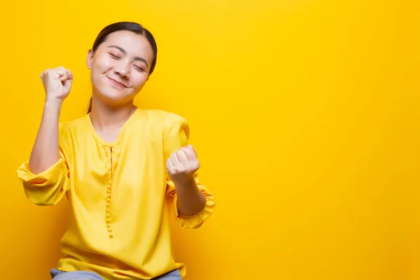 Mujer feliz hacer gesto ganador aislado sobre fondo amarillo —  Fotos de Stock