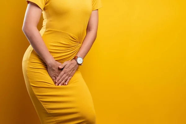 Closeup sick woman with hands holding pressing her crotch isolat — Stock Photo, Image