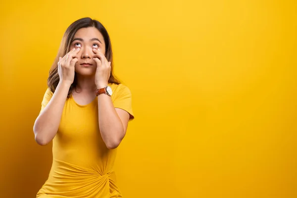 Femme a des douleurs oculaires isolées sur fond jaune — Photo