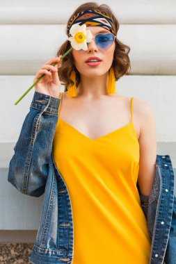beautiful woman in yellow stylish dress wearing denim jacket, posing with flower, trendy outfit, hippie indie style, spring summer fashion trend, blue sunglasses, street fashion clipart