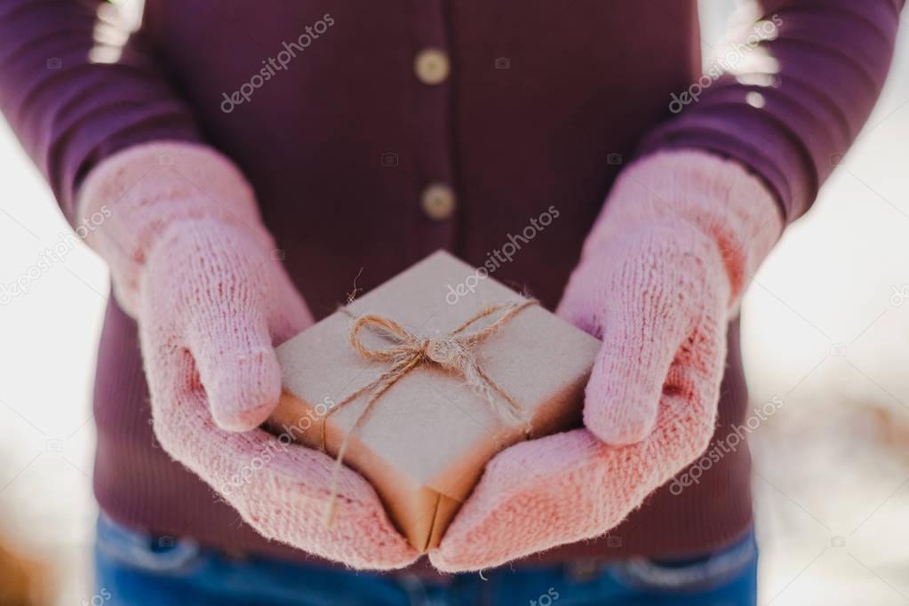 girl with a gift in her hands. adolescent winter outdoor