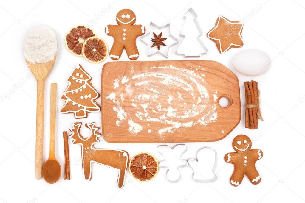 Creative winter time baking background. Kitchen utensils and ingredients for christmas homemade gingerbread cookies on white background